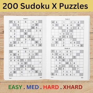 May include: A book titled "200 Sudoku X Puzzles" with four puzzles displayed. The puzzles are in a grid format with numbers. The difficulty levels are indicated at the bottom: EASY, MED, HARD, and XHARD. The book is open on a light wood surface.