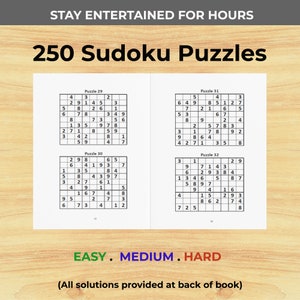May include: A collection of 250 Sudoku puzzles, divided into three difficulty levels: Easy, Medium, and Hard. The puzzles are printed on white paper with black ink. The text "STAY ENTERTAINED FOR HOURS" is printed at the top of the page, and the text "(All solutions provided at back of book)" is printed at the bottom of the page.