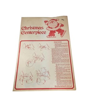 May include: A vintage Christmas Centerpiece craft instruction sheet. The sheet features a red and white illustration of Santa Claus ice skating, along with diagrams for assembling a Christmas centerpiece. The text "Christmas Centerpiece" is in red.