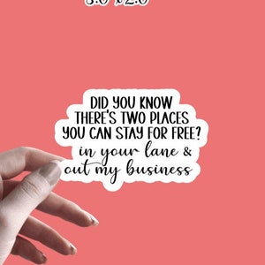 May include: A white sticker with black text that reads "Did you know there's two places you can stay for free? In your lane & out my business". The sticker is 3 inches by 2 inches.