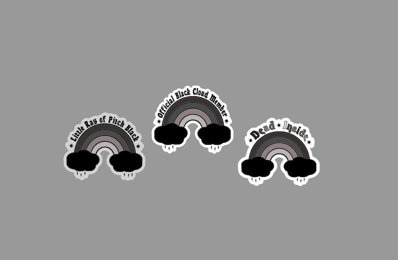 May include: Three black and white rainbow stickers with different text. The first sticker says "Little Ray of Pitch Black". The second sticker says "Official Black Cloud Member". The third sticker says "Dead Inside".