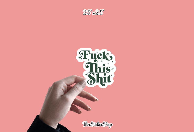 May include: A white sticker with the text "Fuck This Shit" in dark green, with decorative flourishes. The sticker is 2.5 x 2.5 inches and held by a hand against a pink background. The sticker is from Thee Sticker Shop.