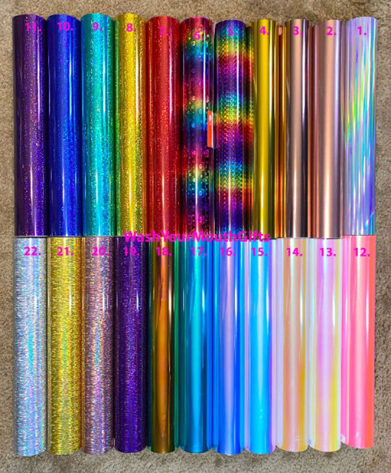 May include: Twenty-two rolls of iridescent vinyl in various colors, including purple, blue, green, gold, and pink. The rolls are numbered 1 through 22.