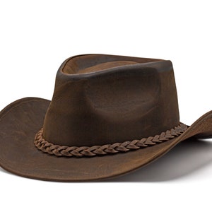May include: A brown leather cowboy hat with a braided leather band.