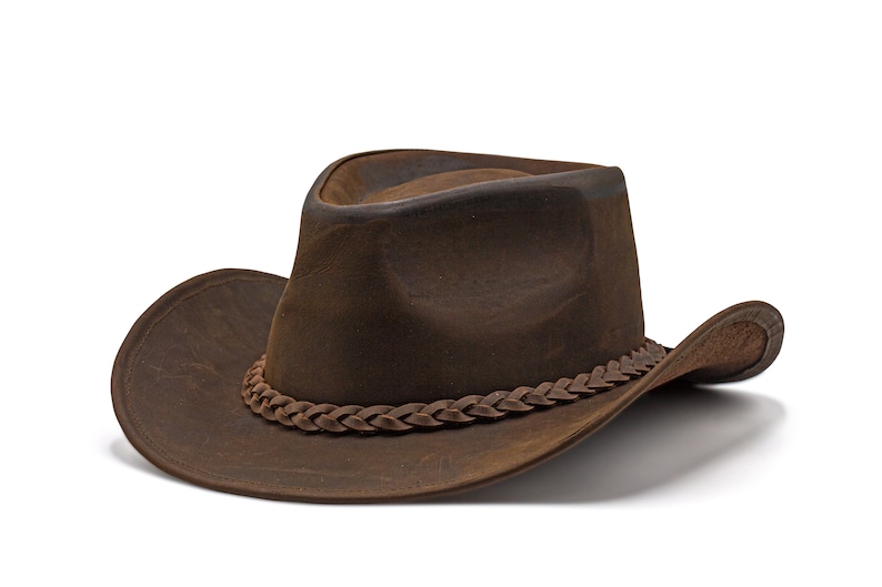 May include: A brown leather cowboy hat with a braided leather band.