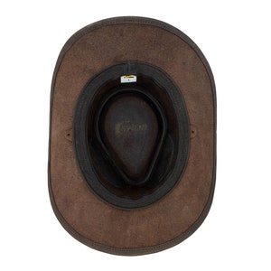 May include: A brown leather cowboy hat with a black leather band and a brown leather lining. The hat has a wide brim and a tall crown.