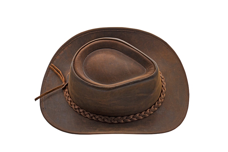 May include: A brown leather cowboy hat with a braided band.