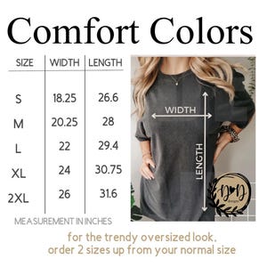May include: A dark gray t-shirt with a size chart showing measurements in inches. The text "Comfort Colors" is at the top. The chart lists sizes S to 2XL with width and length measurements. The text "for the trendy oversized look, order 2 sizes up from your normal size" is at the bottom.
