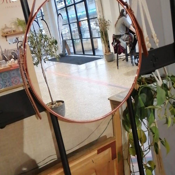 Leather belt Strap Hanging Wall Mirror. Diameter length across the round mirror is 40cm.