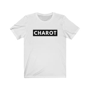 May include: White t-shirt with a black rectangle that says "CHAROT" in white letters.