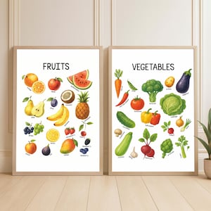 May include: Two framed wall art prints featuring educational illustrations of produce. The left print is titled FRUITS and displays various colorful fruits with labels. The right print is titled VEGETABLES and shows assorted vegetables with labels.