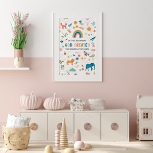 May include: A white framed print with a colorful illustration of animals, plants, and a rainbow. The text reads "In the beginning God created the heaven and the earth, Genesis 1:1".