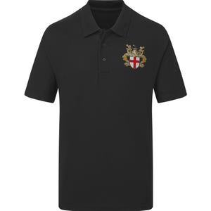May include: Black polo shirt with a gold embroidered crest featuring a shield with a red cross and two gold lions.