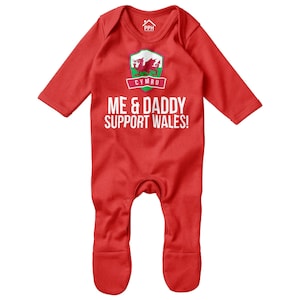 May include: Red baby onesie with a white Welsh dragon logo and the text "Me & Daddy Support Wales!"