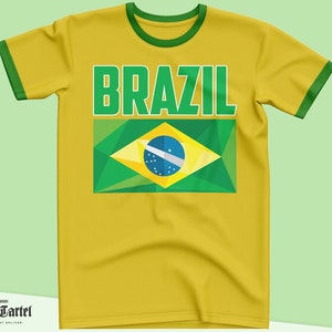 May include: Yellow t-shirt with a green and yellow Brazilian flag and the word "BRAZIL" in green letters.