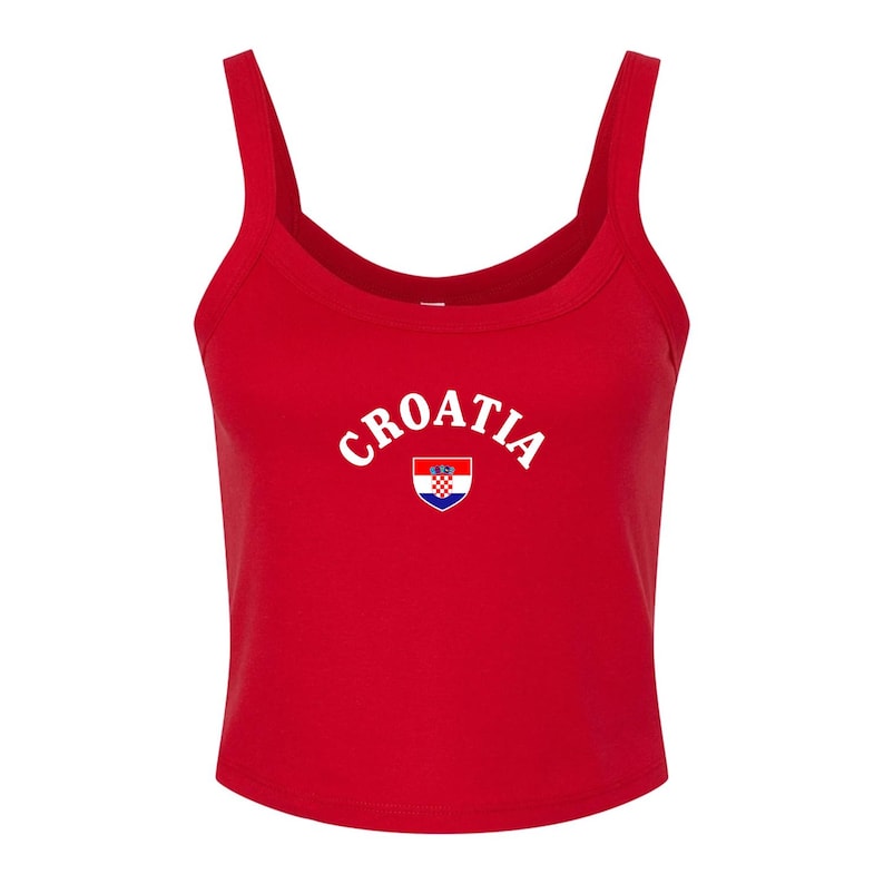 May include: A red crop top with a scoop neck and wide straps. The word "CROATIA" is printed in white arched letters across the chest, above a small Croatian coat of arms.