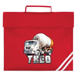May include: A bright red school bag with a white and orange cement mixer truck graphic. The name "THEO" is printed in a distressed font below the truck. The bag has a handle and white stripes on the right side.