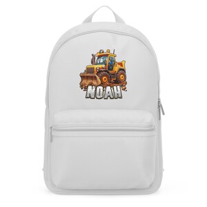 May include: White backpack featuring a colorful illustration of a yellow construction vehicle with the name "NOAH" in brown letters. The backpack has a large main compartment and a front pocket.
