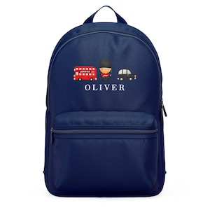 Peut inclure: Sac à dos bleu marine avec un motif sur le thème de Londres. Il présente un bus à impériale rouge, un garde britannique et un taxi noir. Le nom "OLIVER" est imprimé en blanc. Le sac à dos a une poignée et une poche avant.