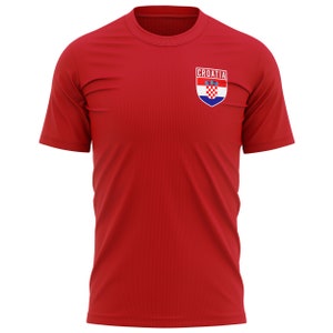 May include: Red t-shirt with a small embroidered patch featuring the Croatian coat of arms and the word "CROATIA" above it.
