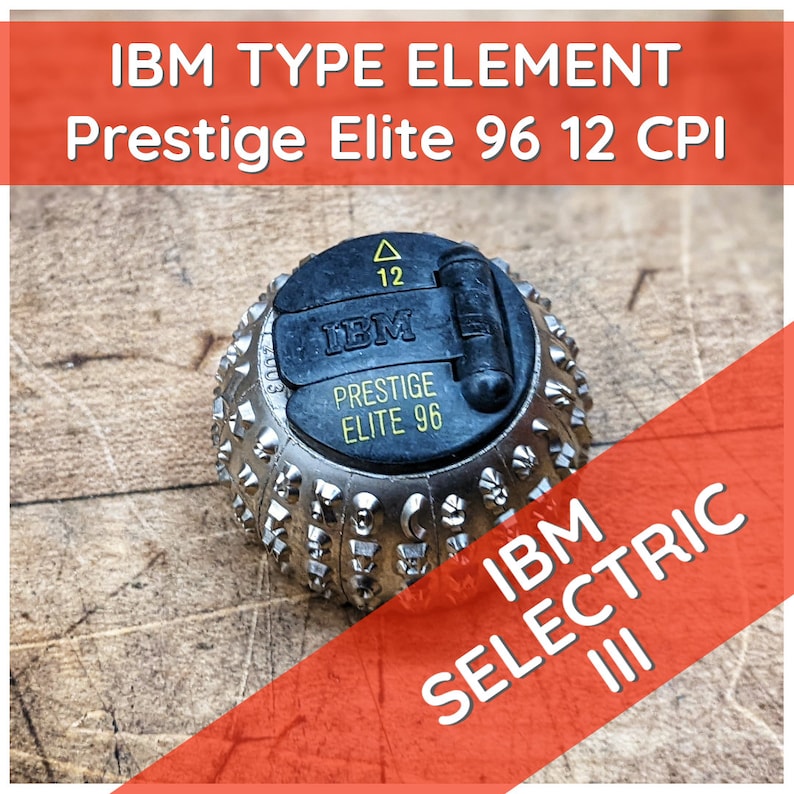 May include: A silver typewriter element for an IBM Selectric III typewriter. The element is labeled "IBM Prestige Elite 96 12 CPI".