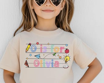 Camiseta escolar con nombre personalizado, camiseta con nombre para niños, camiseta "A" (a de "a"), camiseta escolar con lazo coqueto, camiseta de jardín de infantes, camiseta para el primer día de clases