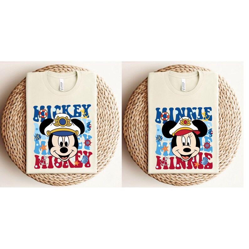 May include: Two beige t-shirts with a nautical theme. The left shirt features Mickey Mouse wearing a captain's hat and the text "Mickey Mouse". The right shirt features Minnie Mouse wearing a captain's hat and the text "Minnie Mouse".