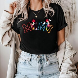 May include: Black t-shirt with a graphic of two cartoon mice and the word "MIMI" in colorful letters.