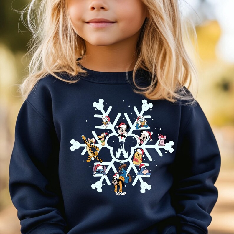 May include: A navy blue sweatshirt with a white snowflake design featuring various Disney characters wearing Santa hats. The characters include Mickey Mouse, Minnie Mouse, Donald Duck, Goofy, Pluto, and others. The snowflake design also includes a silhouette of the Cinderella Castle.