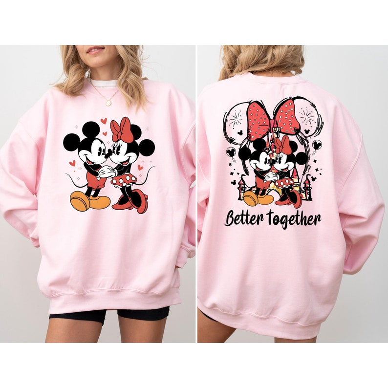 May include: Pink sweatshirt with a graphic of Mickey and Minnie Mouse on the front and the text "Better Together" on the back.