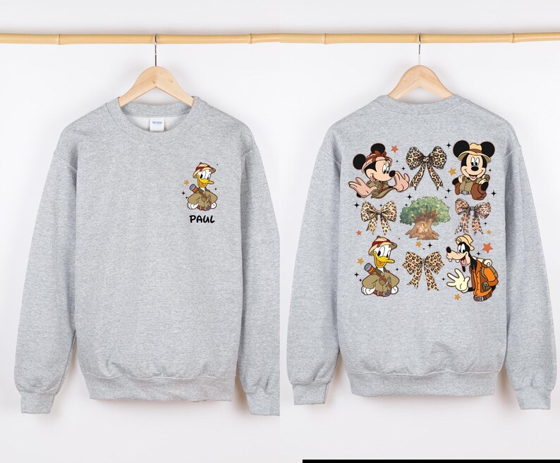 May include: A gray sweatshirt with a cartoon image of Donald Duck and Mickey Mouse on the back. The front of the sweatshirt has a cartoon image of Donald Duck and the name "Paul" printed on it.