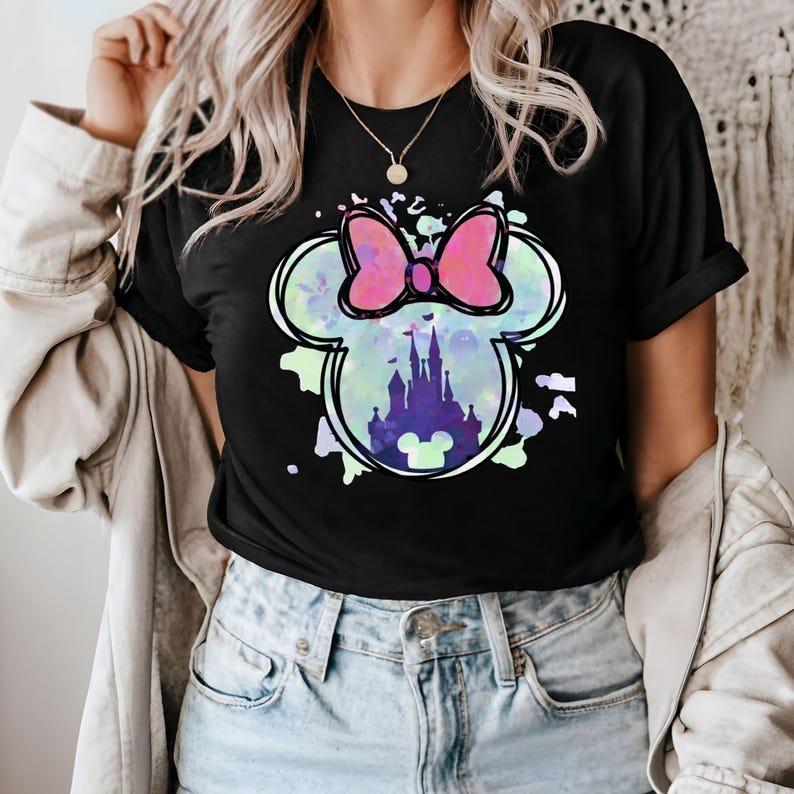May include: Black t-shirt with a colorful graphic of Mickey Mouse ears with a pink bow and a silhouette of Cinderella's castle inside.
