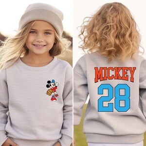 May include: Gray sweatshirt with a Mickey Mouse baseball player graphic on the front and "MICKEY 28" on the back.