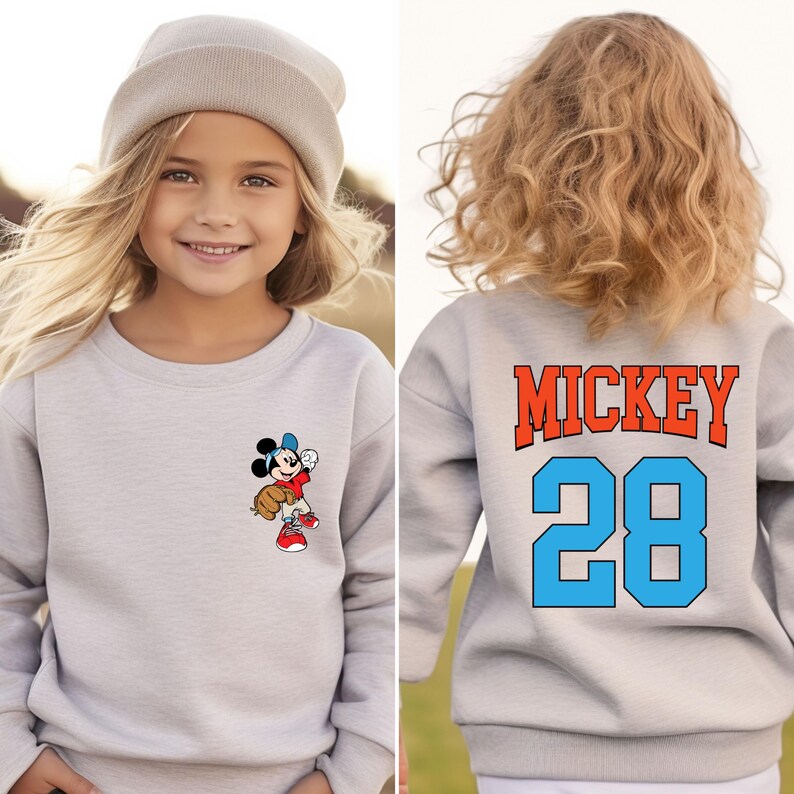 May include: Gray sweatshirt with a Mickey Mouse baseball player graphic on the front and "MICKEY 28" on the back.
