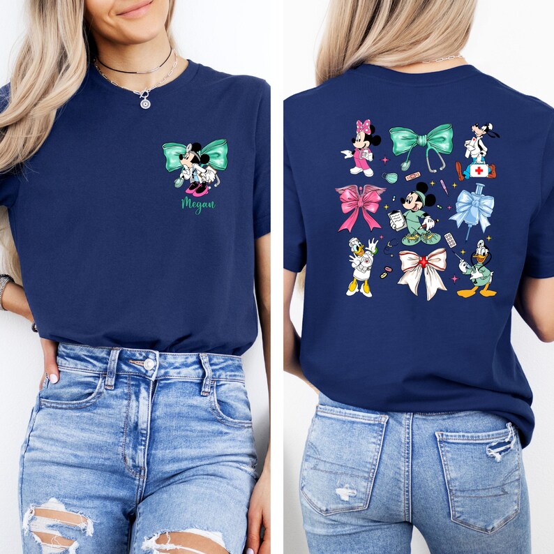 May include: Navy blue t-shirt featuring a Minnie Mouse and Mickey Mouse design with a teal bow and the name "Megan". The back of the shirt displays various cartoon characters and bows. The shirt is made of a soft material.