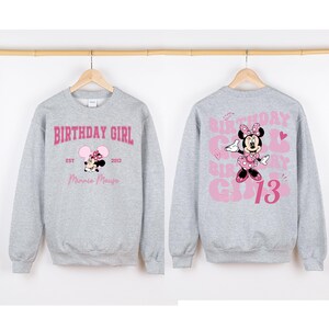 May include: Gray sweatshirt with a pink Minnie Mouse graphic and the text "Birthday Girl" on the front and "Birthday Girl 13" on the back.