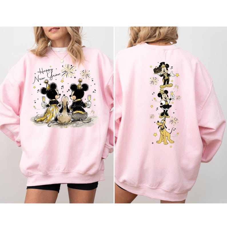 Puede incluir: Sudadera rosa claro con un dise&ntilde;o festivo de Mickey y Minnie Mouse celebrando el A&ntilde;o Nuevo. La parte delantera muestra a la pareja con copas de champ&aacute;n, mientras que la parte trasera los muestra con Pluto. Tambi&eacute;n se ve el texto "Happy New Year".