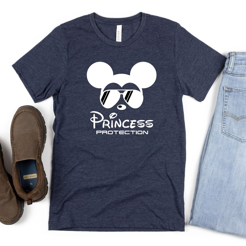 May include: A navy blue t-shirt with a white Mickey Mouse graphic wearing sunglasses and the text "Princess Protection".