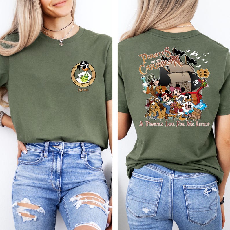 May include: A green t-shirt with a cartoon image of a pirate duck on the front and a group of Disney characters on the back. The back of the shirt says "Pirates of the Caribbean" and "A Pirate's Life for Me, Lads".