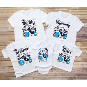 May include: Set of five white t-shirts with Mickey Mouse and friends graphics. The shirts say "Daddy of the Birthday Boy", "Mommy of the Birthday Boy", "Brother of the Birthday Boy", "Sister of the Birthday Boy", and "2nd Birthday Boy Jordan".