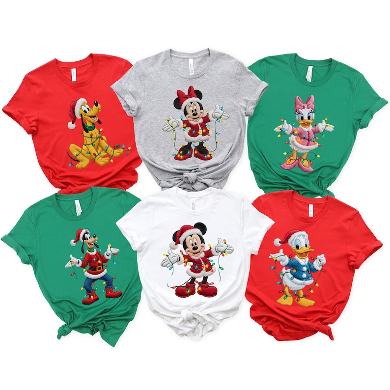 May include: Six Christmas-themed t-shirts in a variety of colours, including red, green, grey, and white. Each shirt features a different cartoon character, such as Mickey Mouse, Pluto, and Donald Duck, dressed in festive holiday attire, perfect for the Christmas season.