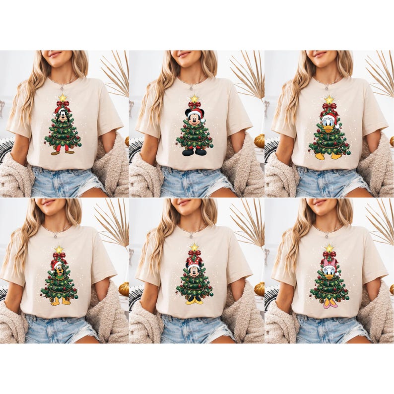 May include: Beige t-shirts featuring Christmas tree designs with cartoon characters. Each shirt showcases a different character, including Mickey Mouse, Minnie Mouse, Donald Duck, and Goofy, all dressed in festive attire. The trees are decorated with ornaments and topped with a star.