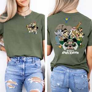 May include: A green t-shirt with a graphic of Mickey Mouse and friends in a jungle setting. The front of the shirt has a smaller graphic of Mickey Mouse and friends. The back of the shirt has a larger graphic of Mickey Mouse and friends with the text "Disney's Animal Kingdom".