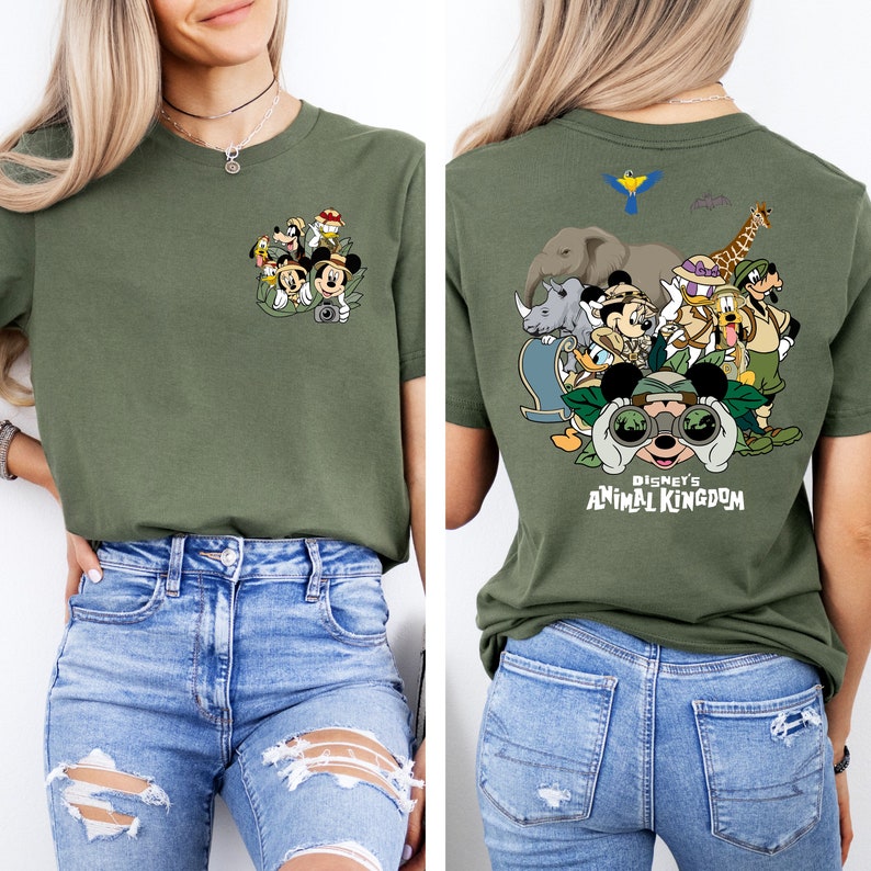 May include: A green t-shirt with a graphic of Mickey Mouse and friends in a jungle setting. The front of the shirt has a smaller graphic of Mickey Mouse and friends. The back of the shirt has a larger graphic of Mickey Mouse and friends with the text "Disney's Animal Kingdom".