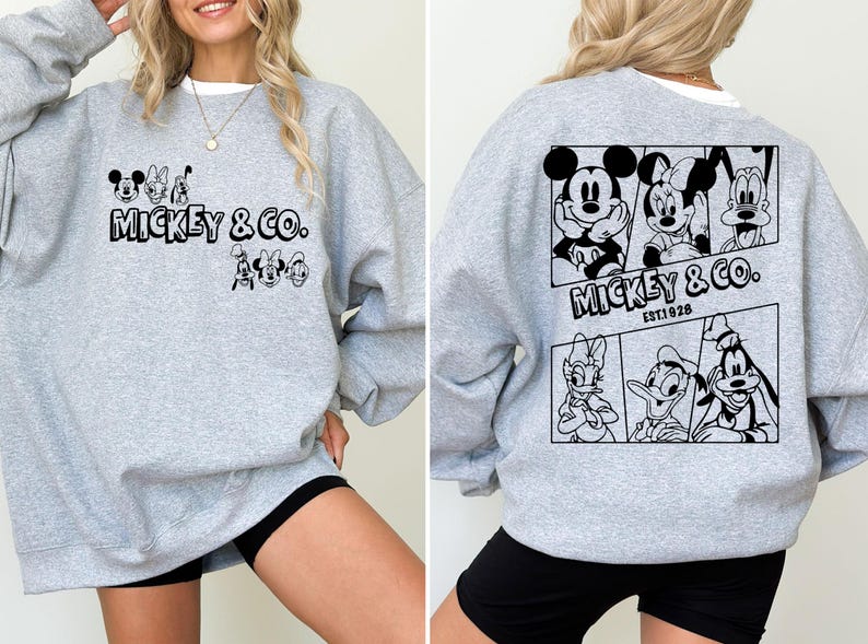 May include: A gray sweatshirt with a black print of Mickey Mouse and friends. The print includes the text "Mickey & Co. Est. 1928".
