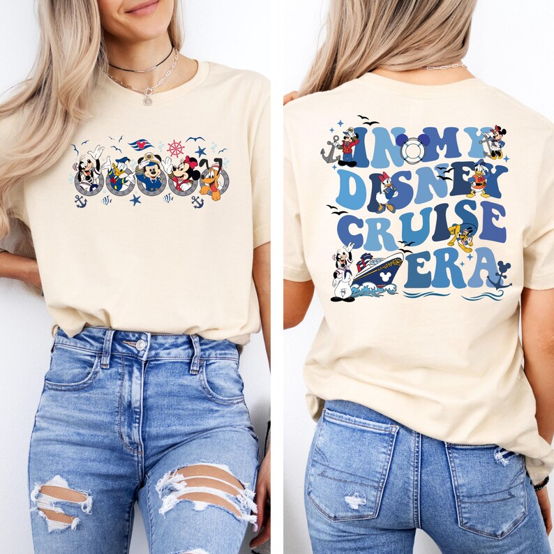 May include: A beige t-shirt with a graphic of Mickey Mouse and friends on a cruise ship on the front. The back of the shirt has the text "In My Disney Cruise Era" in blue and white letters with a graphic of Mickey Mouse and friends.