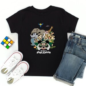 Może przedstawiać: Czarny T-shirt z grafiką przedstawiającą Myszke Miki i jej przyjaci&oacute;ł przed dżunglą. Pod obrazkiem znajduje się napis "Disney's Animal Kingdom".