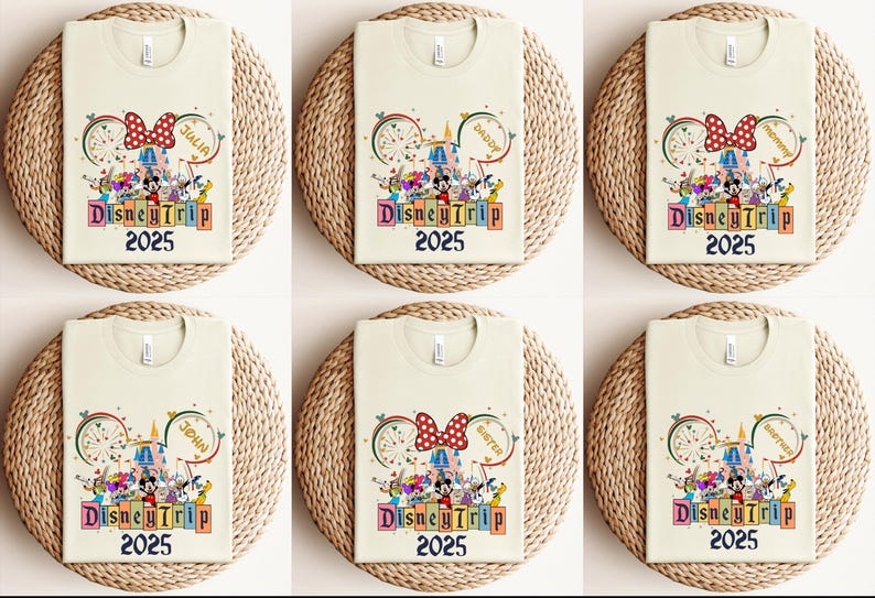 May include: Six cream-colored t-shirts with a colorful Disney-themed design. The design features Mickey Mouse, Minnie Mouse, and other Disney characters. The text "DisneyTrip 2025" is printed on each shirt. The shirts are arranged in two rows of three.