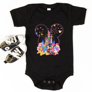 May include: Black baby onesie with a colorful graphic of Mickey Mouse and friends in front of Cinderella's Castle. The graphic is surrounded by a pink Mickey Mouse ear outline.