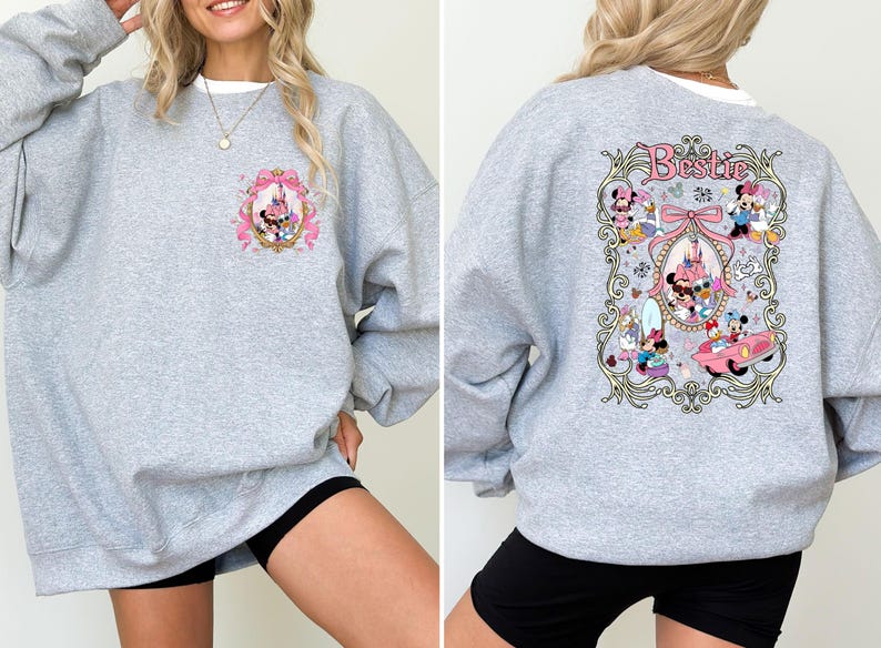 May include: Gray sweatshirt with a pink and white graphic of Disney characters in a frame. The text "Bestie" is on the graphic.